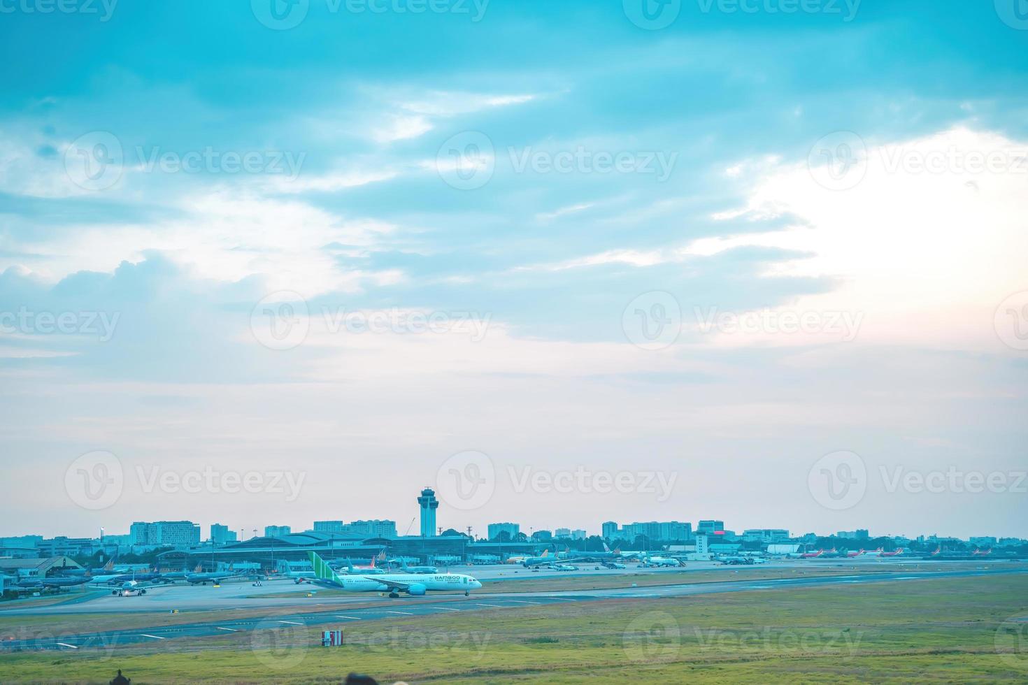 ciudad de ho chi minh, vietnam - 12 de febrero de 2022, un avión vuela sobre áreas urbanas preparando el aterrizaje en el aeropuerto internacional de tan son nhat y despega en el aeropuerto de tsn foto