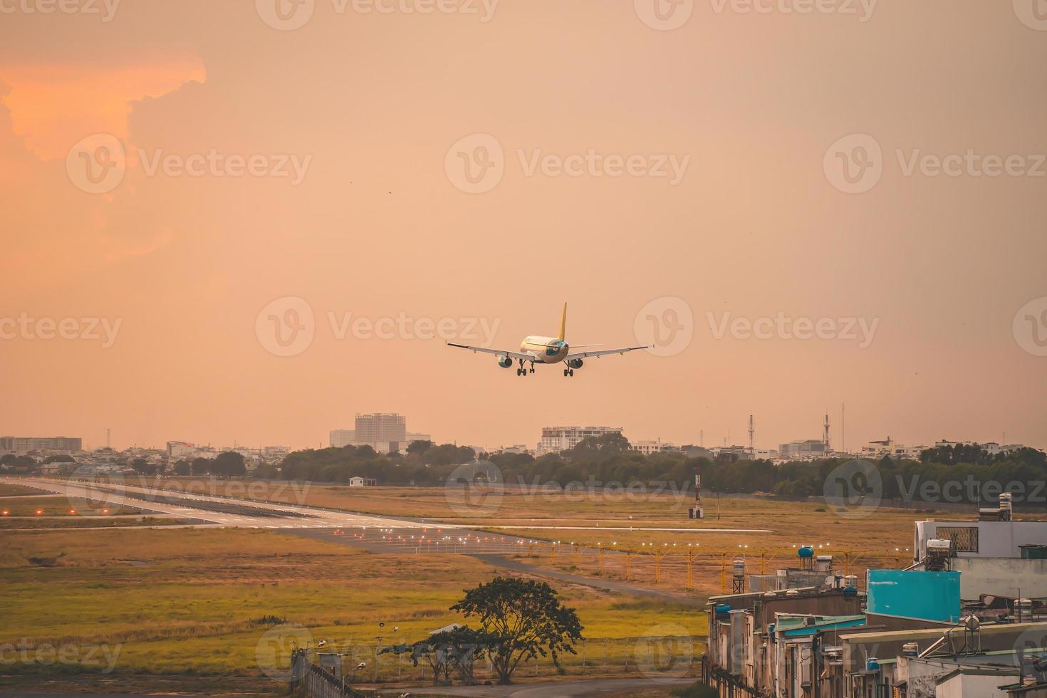 Ho Chi Minh city, Vietnam - FEB 12 2022 Airplane fly over urban areas preparing landing into Tan Son Nhat International Airport and takes off in TSN airport photo