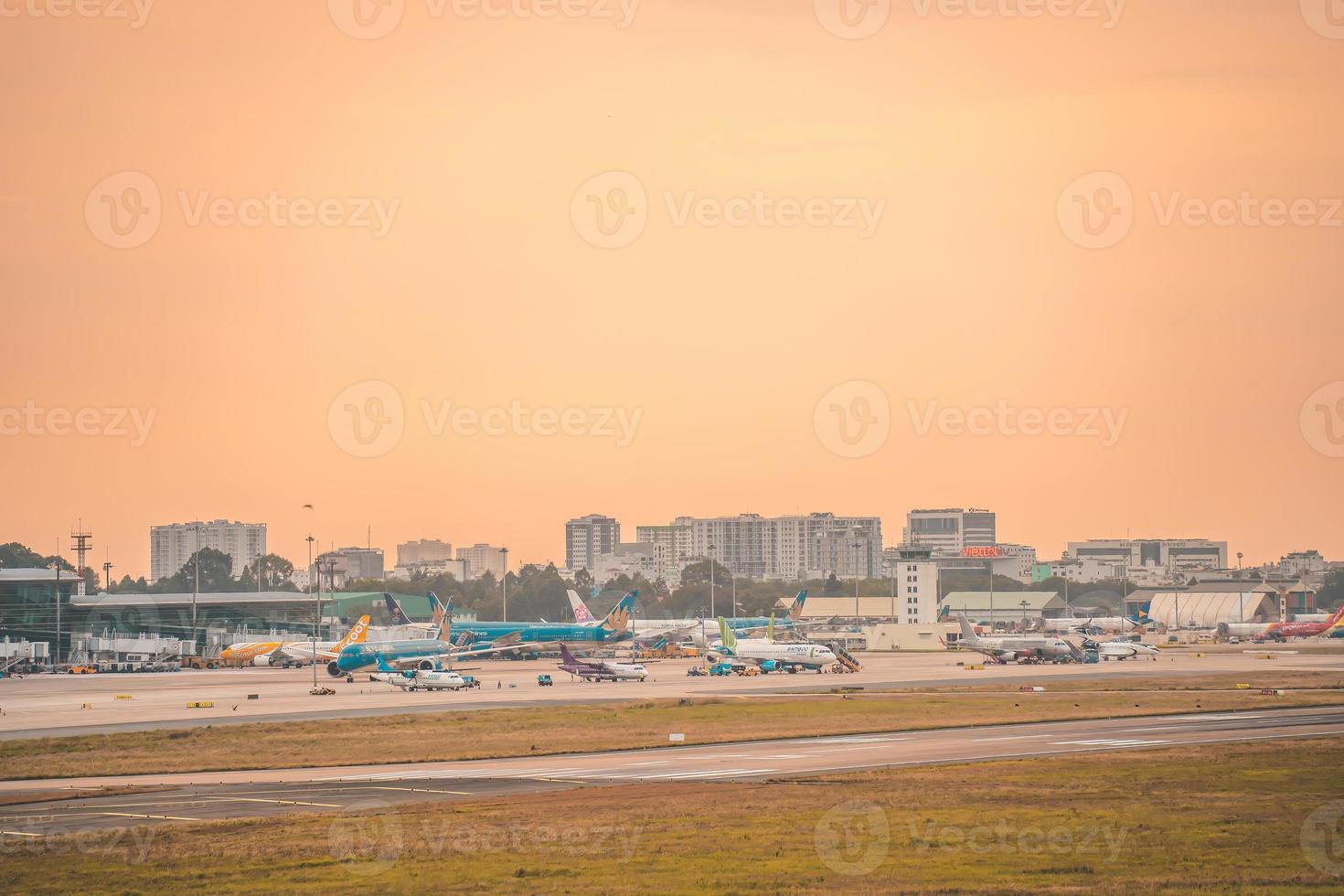 Ho Chi Minh city, Vietnam - FEB 12 2022 Airplane fly over urban areas preparing landing into Tan Son Nhat International Airport and takes off in TSN airport photo