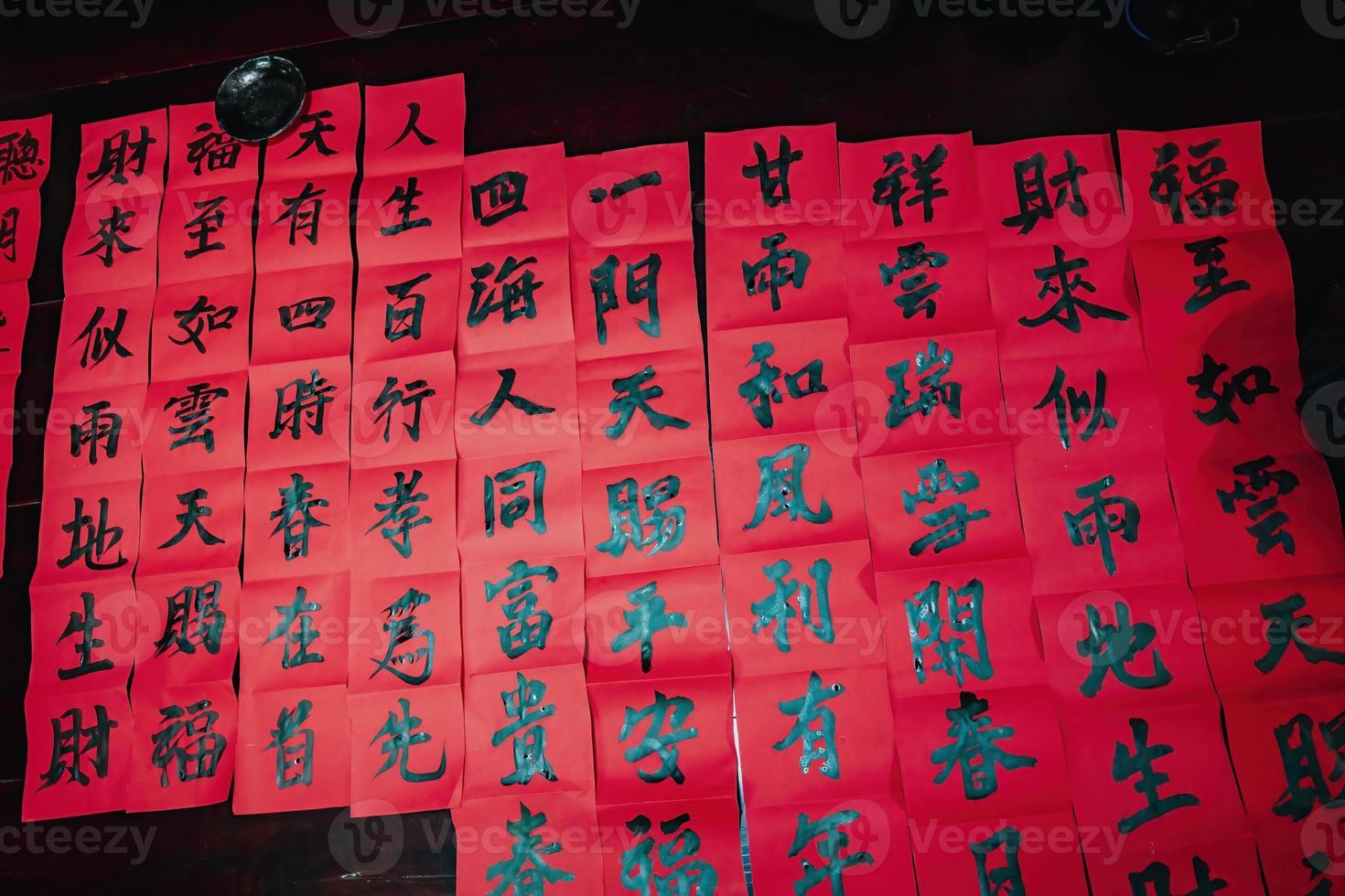 Vietnamese scholar writes calligraphy at Long Son. Calligraphy festival is a popular tradition during Tet holiday. Writing couplets for Spring Festival, new year. photo