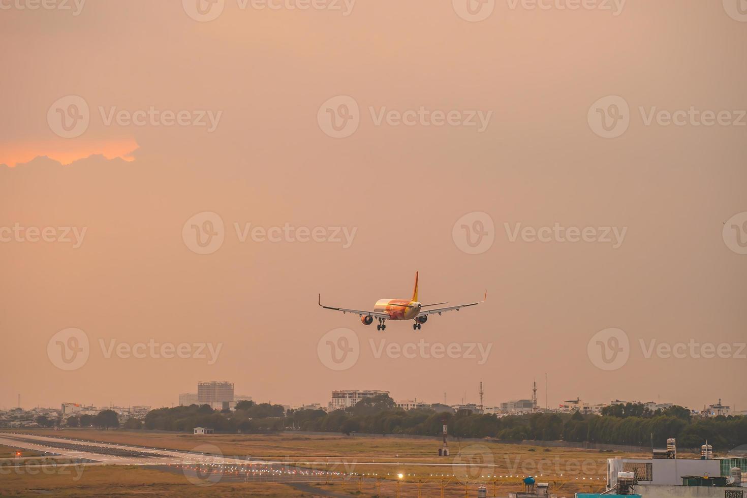 Ho Chi Minh city, Vietnam - FEB 12 2022 Airplane fly over urban areas preparing landing into Tan Son Nhat International Airport and takes off in TSN airport photo