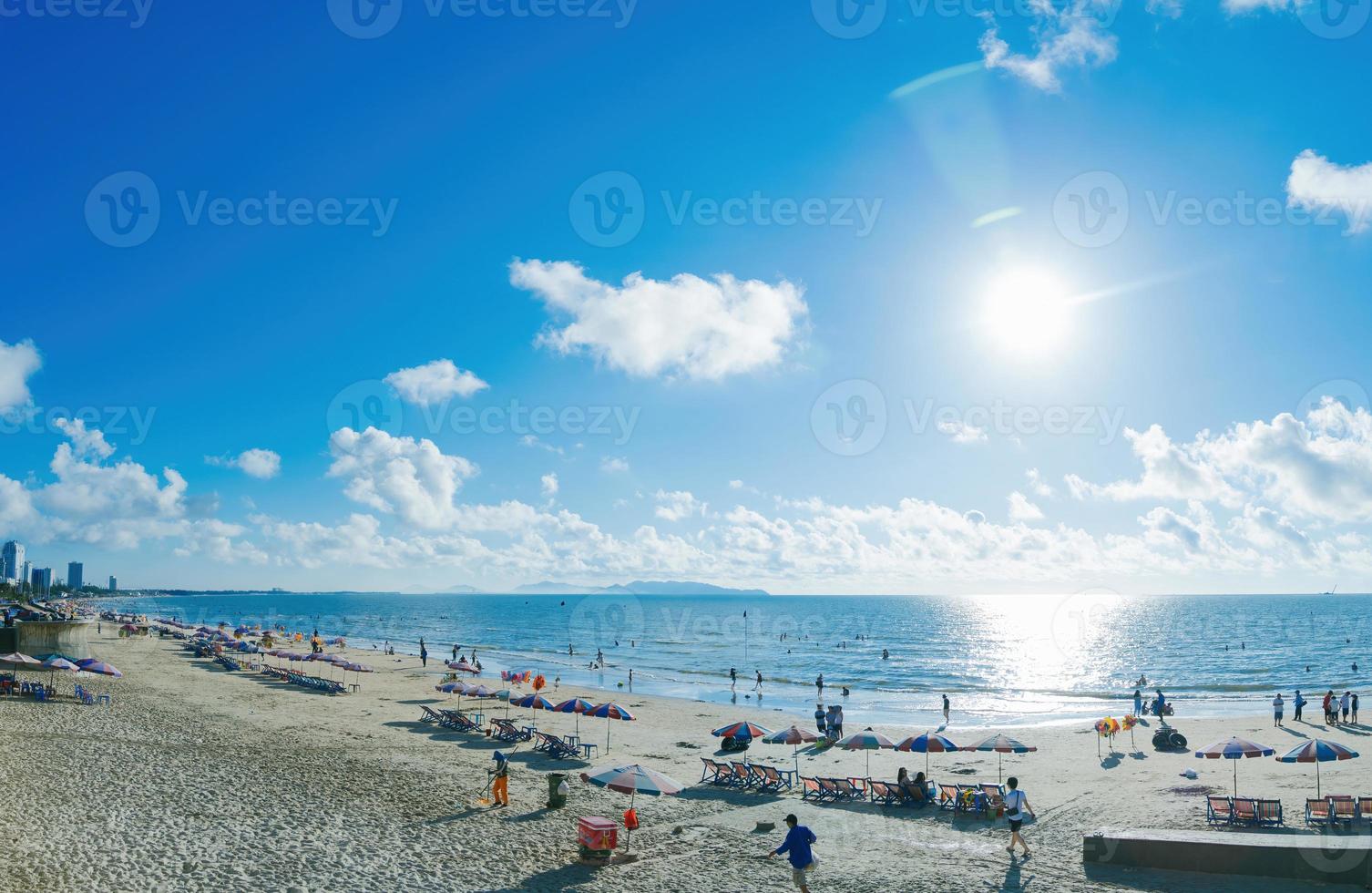 Vung Tau city aerial view with beautiful sunset and so many boats. Panoramic coastal Vung Tau view from above, with waves, coastline, streets, coconut trees and Tao Phung mountain in Vietnam. photo