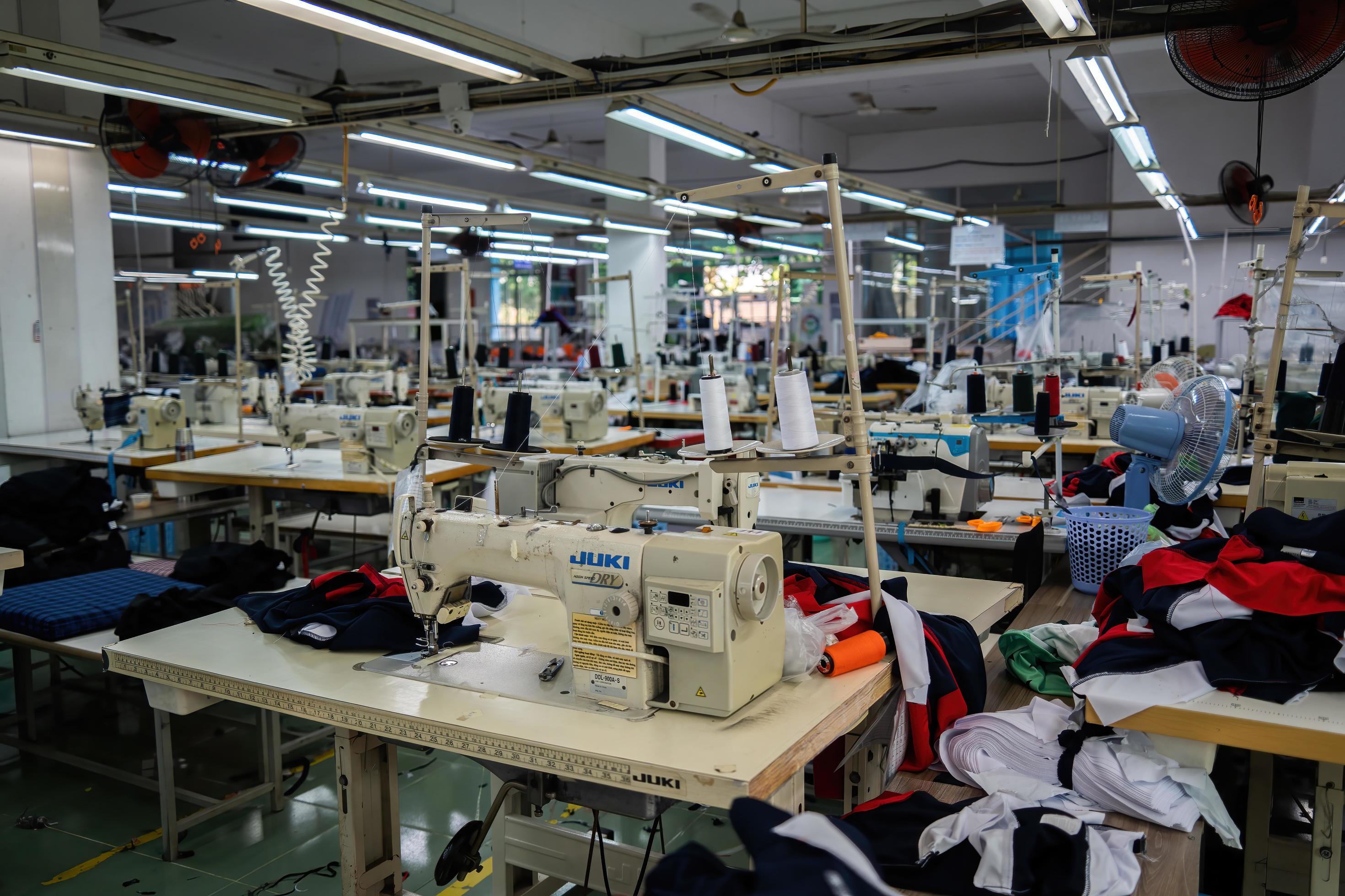 Ba Ria, VIETNAM - MAR 18 2022 Textile cloth factory working process  tailoring workers equipment. This is a sewing machine factory production  empty worker. 10045898 Stock Photo at Vecteezy