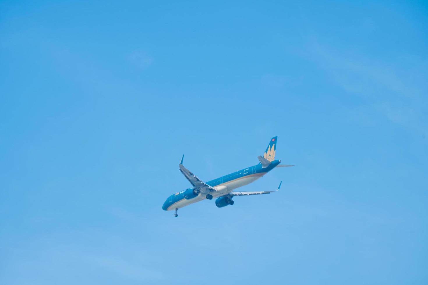 Ho Chi Minh city, Vietnam - FEB 13 2022 Vietnam Airlines fly over urban areas preparing landing into Tan Son Nhat International Airport and takes off in Ho Chi Minh City, Vietnam. photo