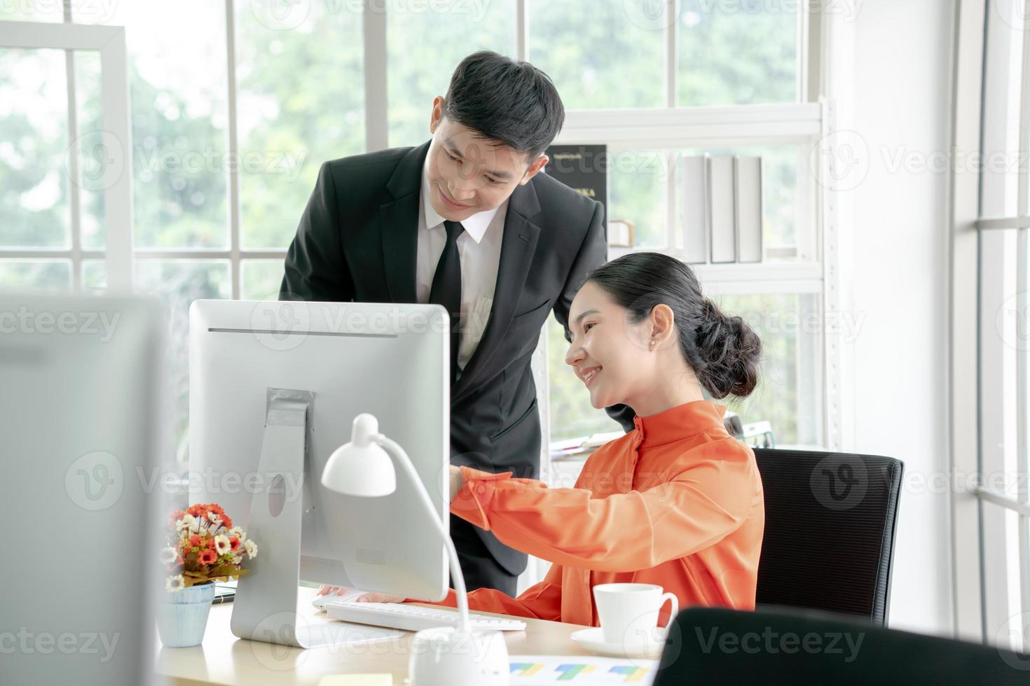 Business people discussing while using computer photo