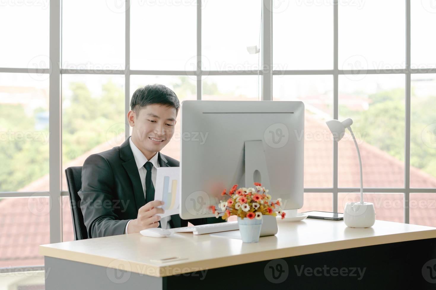 Businessman reading report to understand more about current business situation photo