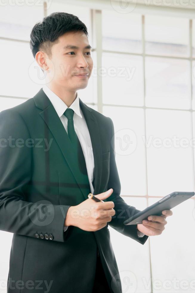 A businessman  analysis document  seen through glass in new office photo