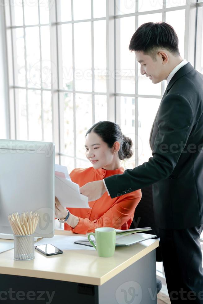 Helpful boss mentor explaining new online project to worker intern photo