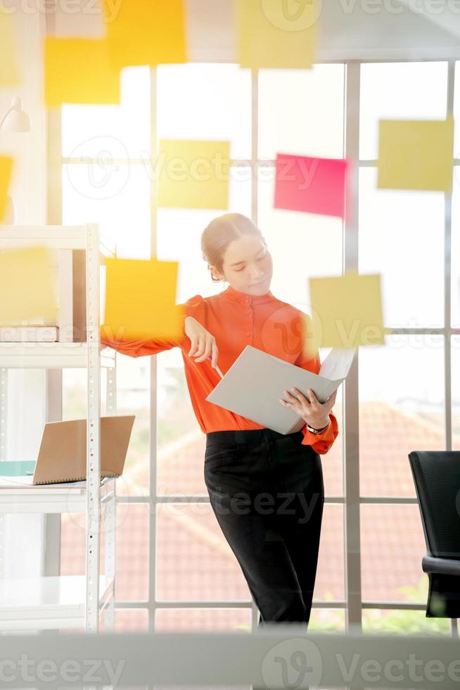 Business woman is reading documents view through window photo