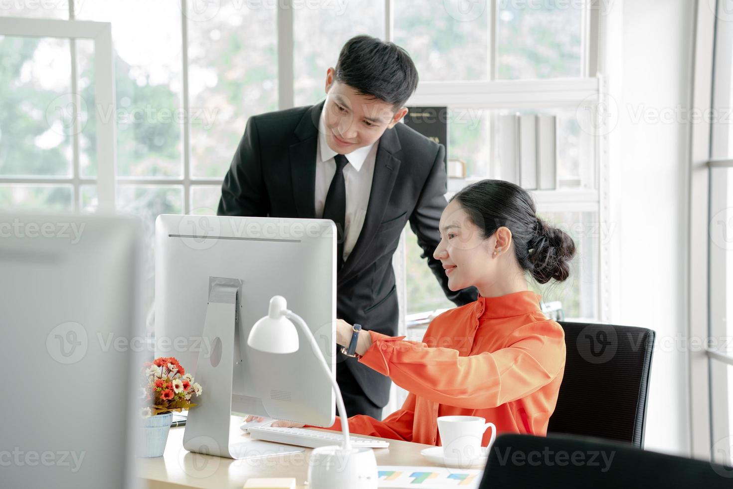 Business people discussing while using computer photo