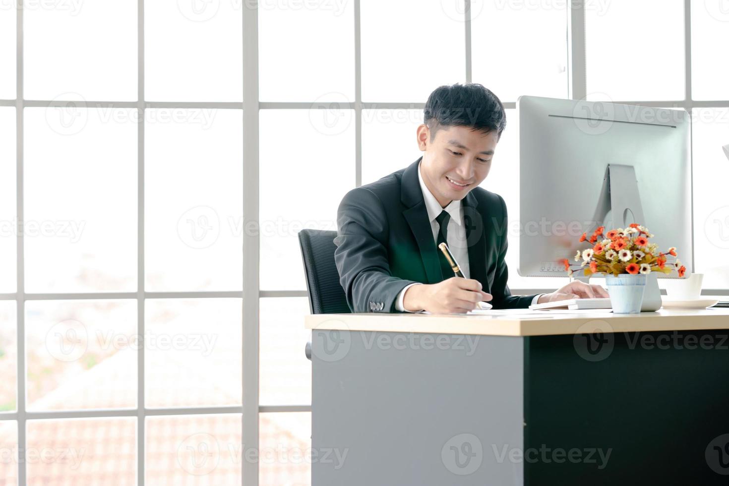 Male manager taking notes in home office photo