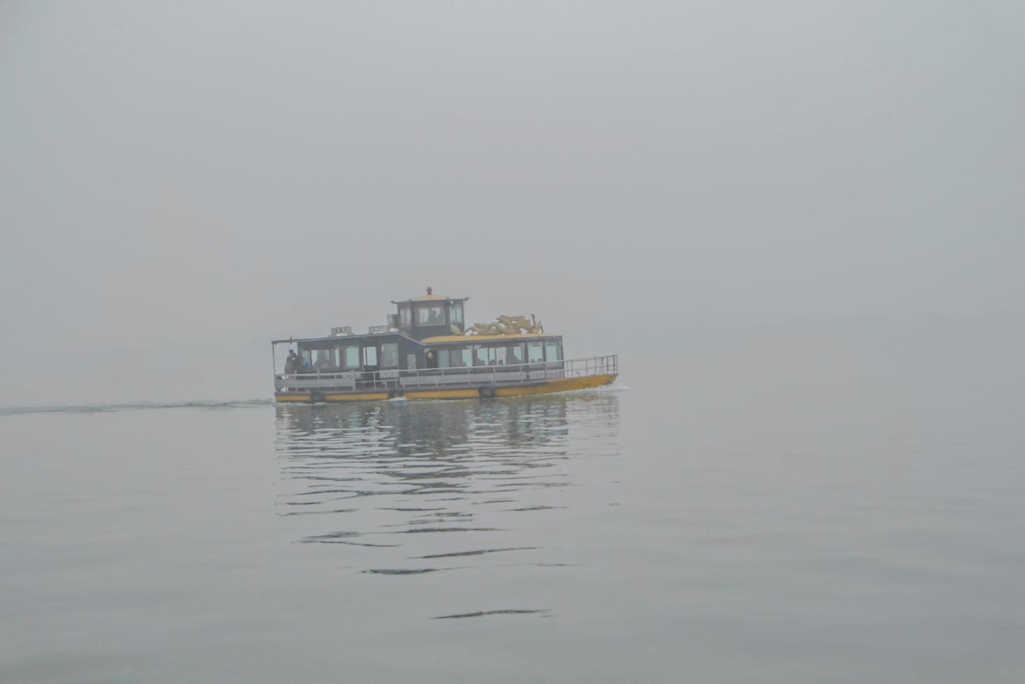 Beautiful Xihu lake one of destination in china with foggy or mist in winter season photo