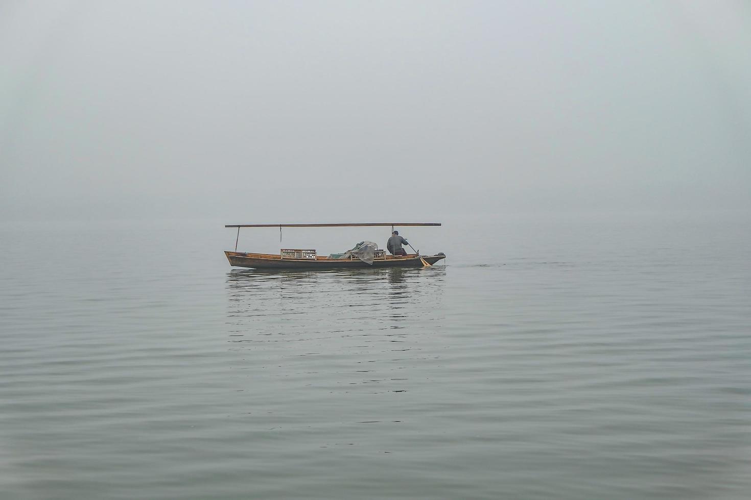 One Boat on beautfiul Xihu lake West Lake one of destination in china with foggy or mist in winter season,hangzhou china photo