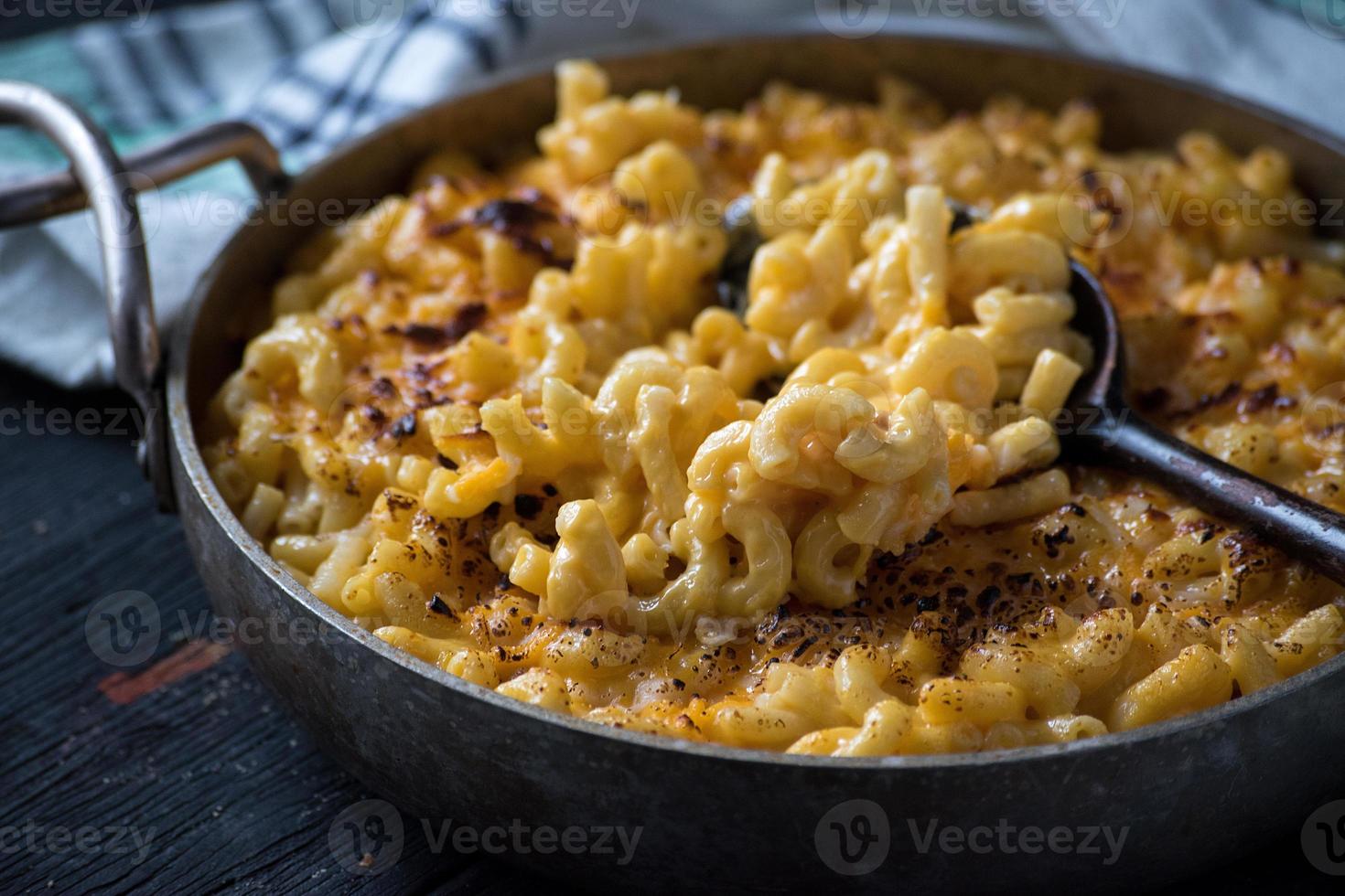 gourmet baked macaroni and cheese noodles in rustic cast iron dish flat lay photo