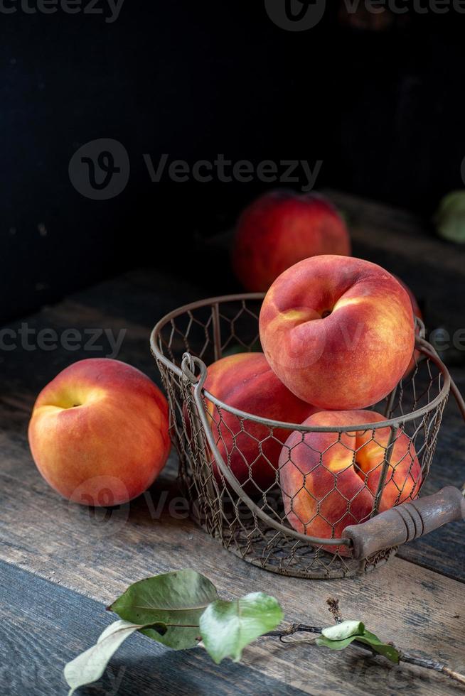 farm fresh peaches on rustic table photo