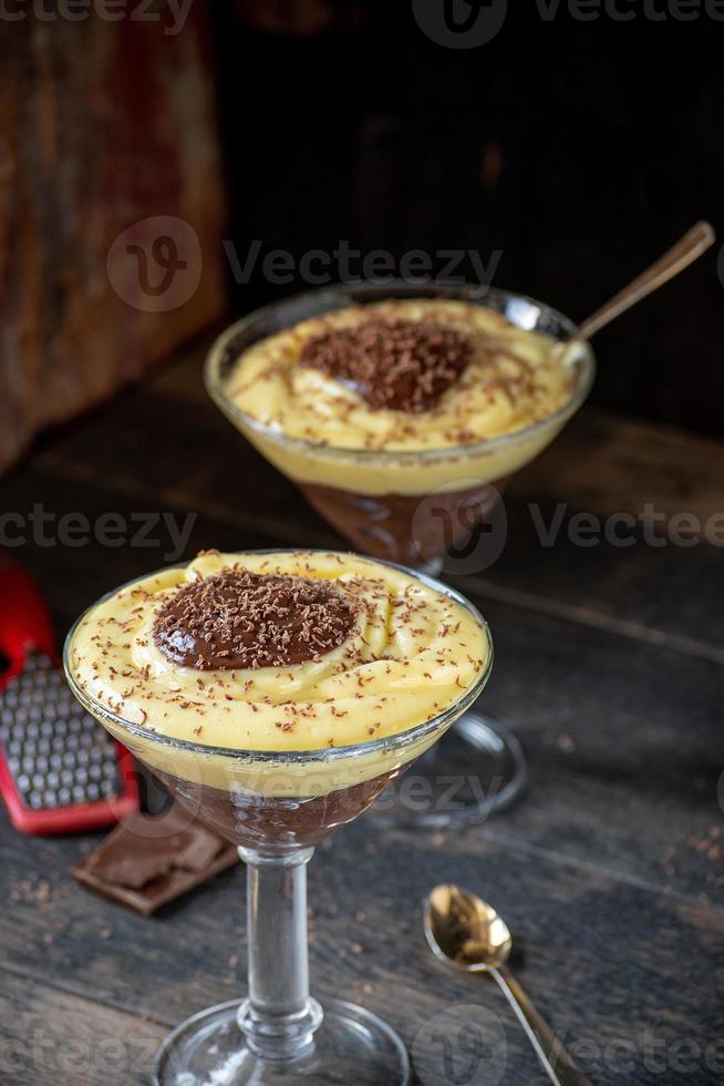 vanilla and chocolate pudding in tall glass with grated chocolate pieces photo