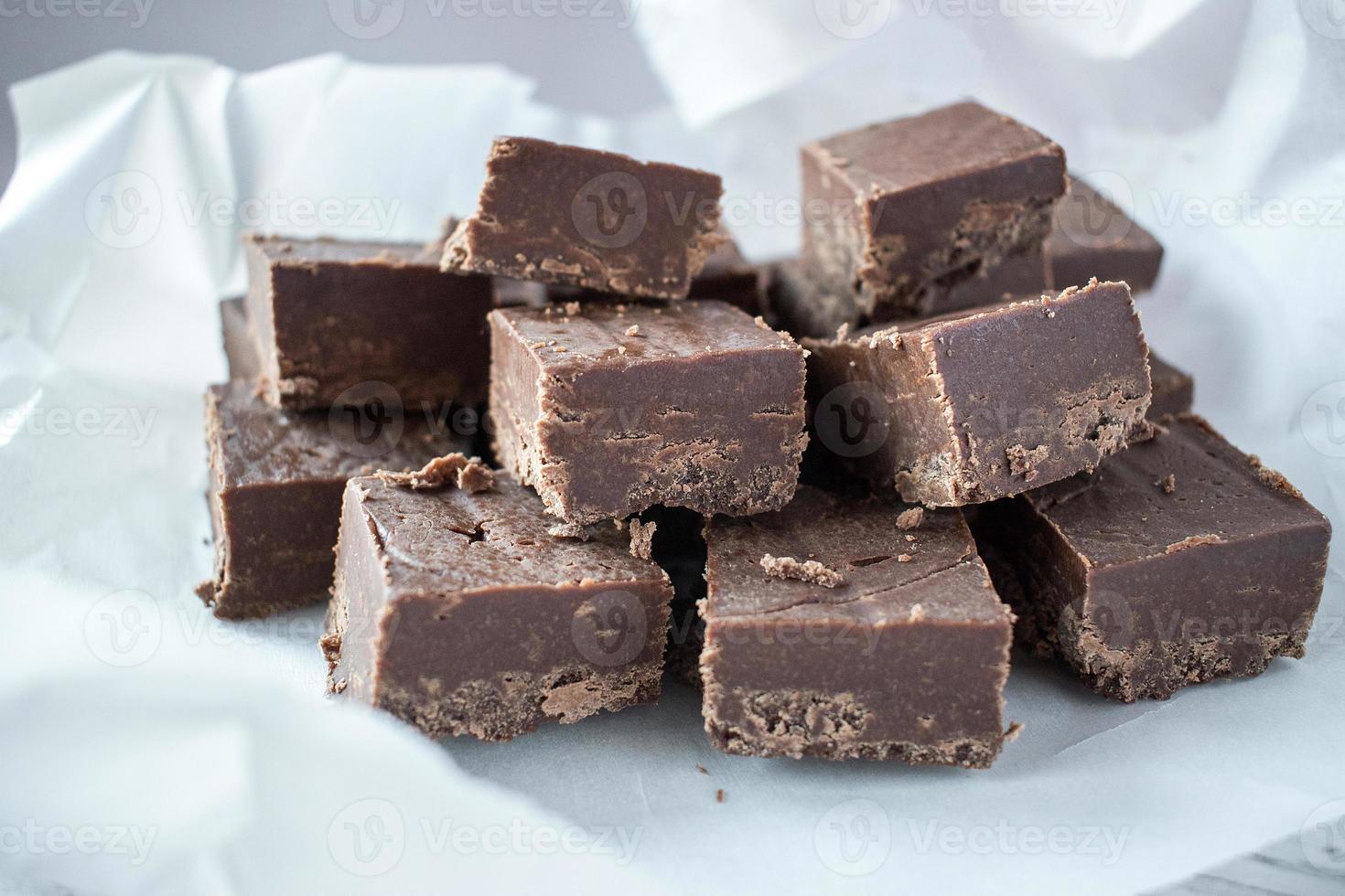 Group of fudge squares on white paper background photo