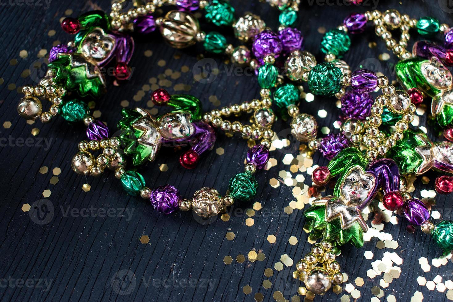 mardi gras beads in gold, green, and purple photo