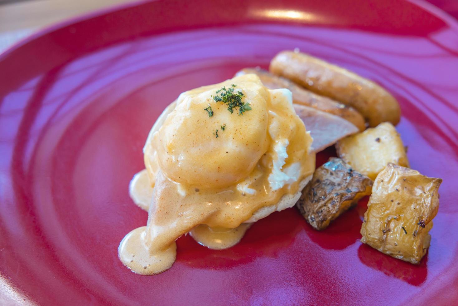 Egg Benedict in a red plate photo