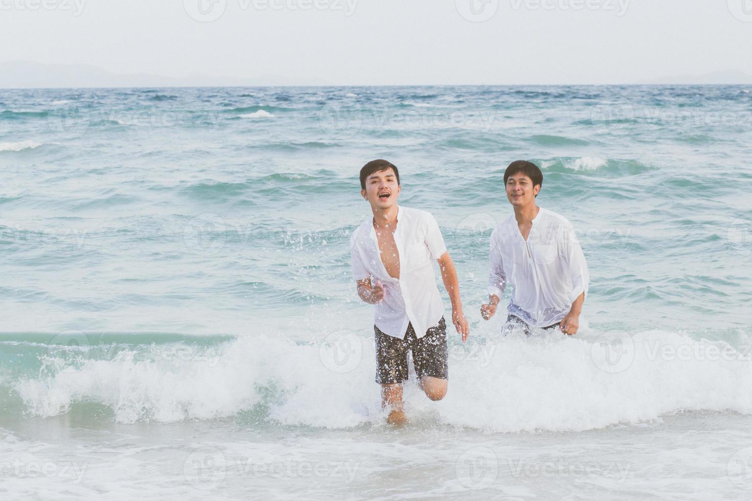 Homosexual portrait young asian couple running with cheerful together on beach in summer, asia gay going tourism for leisure and relax with happiness in vacation at sea, LGBT legal concept. photo