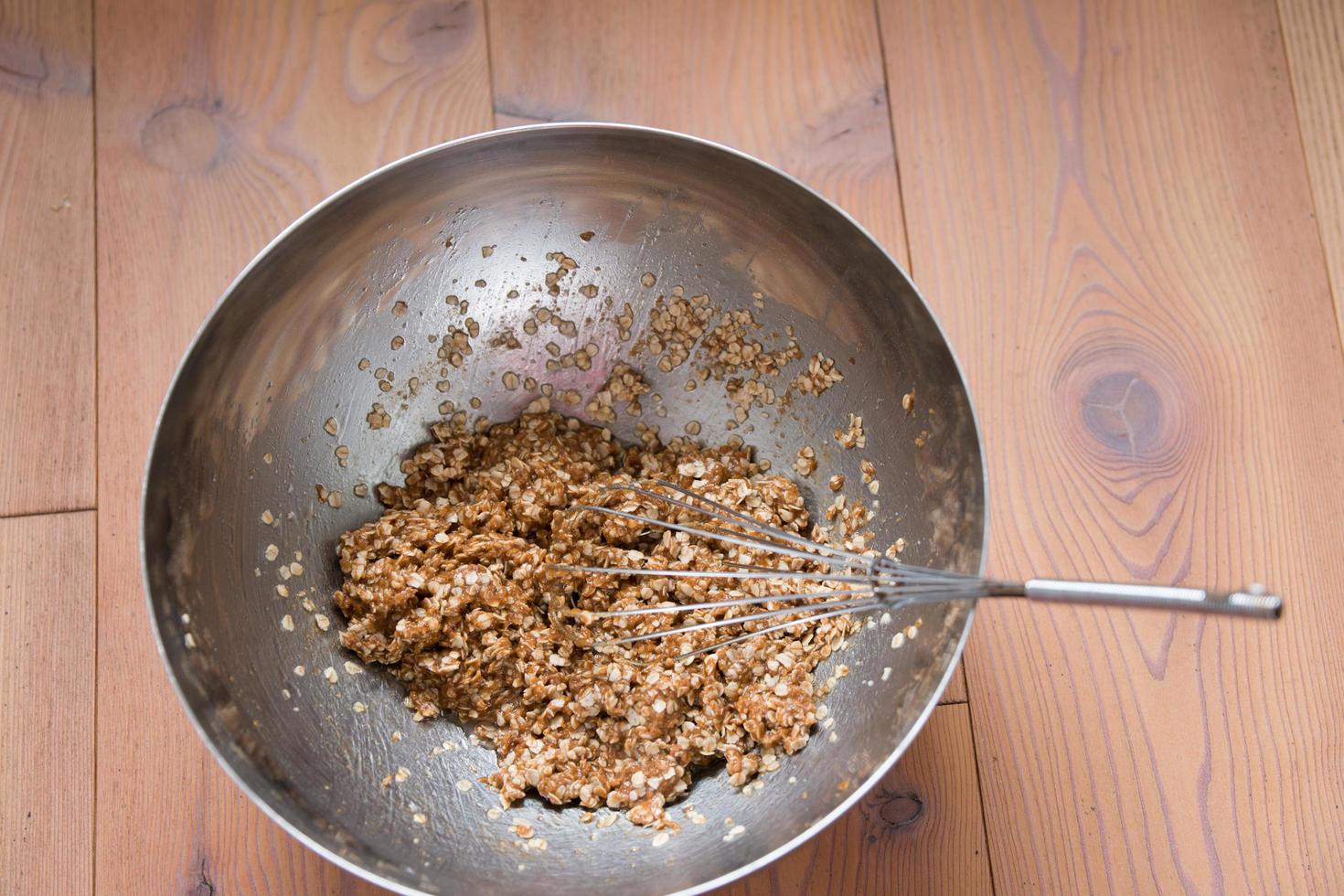 Metallic bowl with the cookies dough. Egg beater. photo