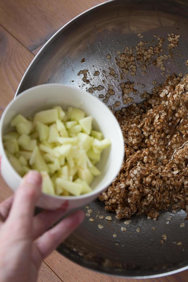 Chopped green apple in a bowl to be added. Baking cookies at home photo