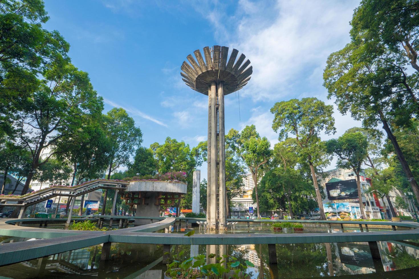 Wide angle view of Lotus pillar - An iconic architecture at Turtle lake , Ho Con Rua with blue sky in Saigon. photo