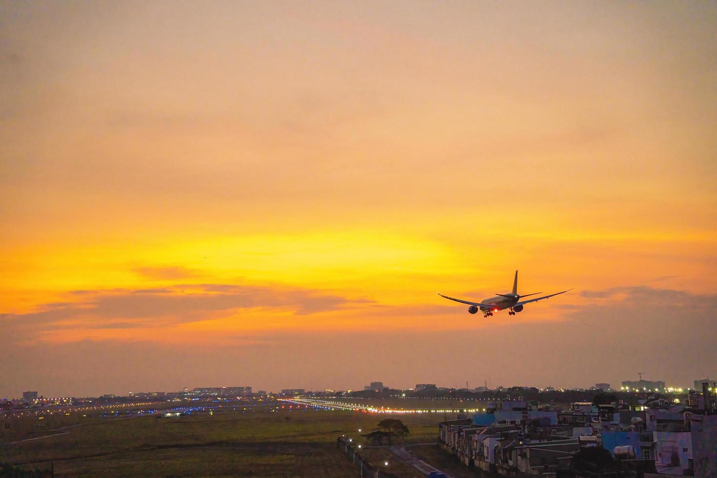 Ho Chi Minh city, Vietnam - FEB 20 2022 Airplane fly over urban areas preparing landing into Tan Son Nhat International Airport and takes off in TSN airport photo