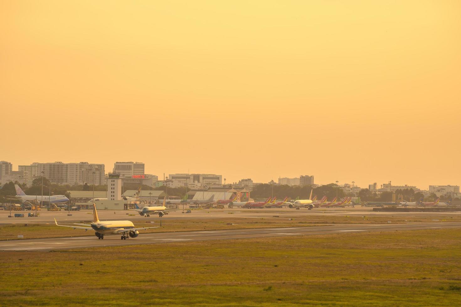 Ho Chi Minh city, Vietnam - FEB 20 2022 Airplane fly over urban areas preparing landing into Tan Son Nhat International Airport and takes off in TSN airport photo