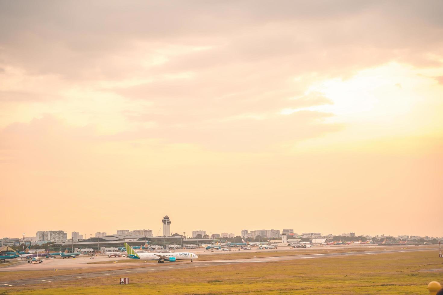 Ho Chi Minh city, Vietnam - FEB 12 2022 Airplane fly over urban areas preparing landing into Tan Son Nhat International Airport and takes off in TSN airport photo