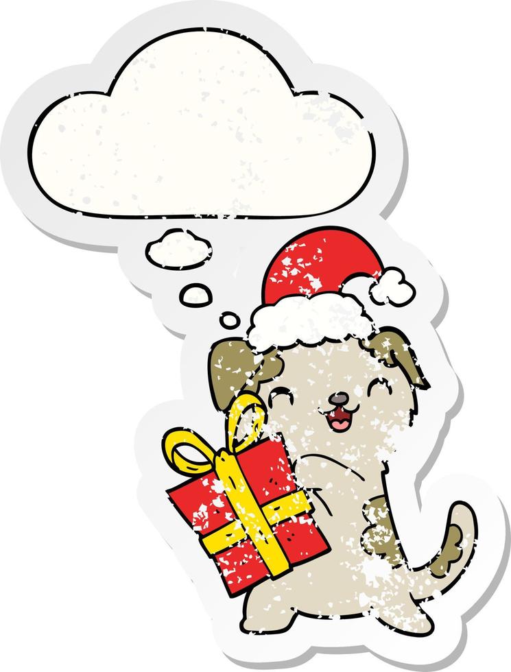 cute cartoon puppy with christmas present and hat and thought bubble as a distressed worn sticker vector