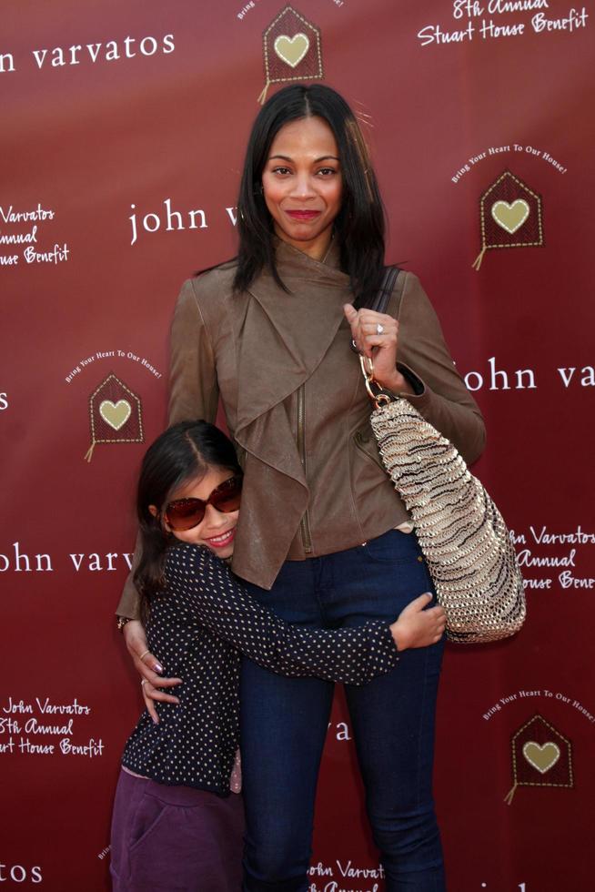 LOS ANGELES, MAR 13 - Zoe Saldana, niece Kayla arriving at the John Varvatos 8th Annual Stuart House Benefit at John Varvaots Store on March 13, 2011 in Los Angeles, CA photo