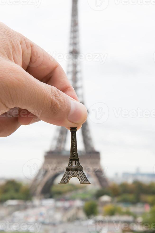 hand hold eiffel model photo