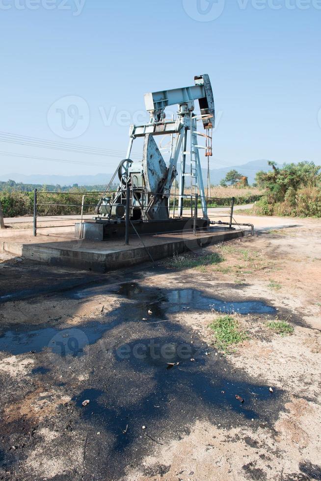 pump jack with crude oil contamination photo
