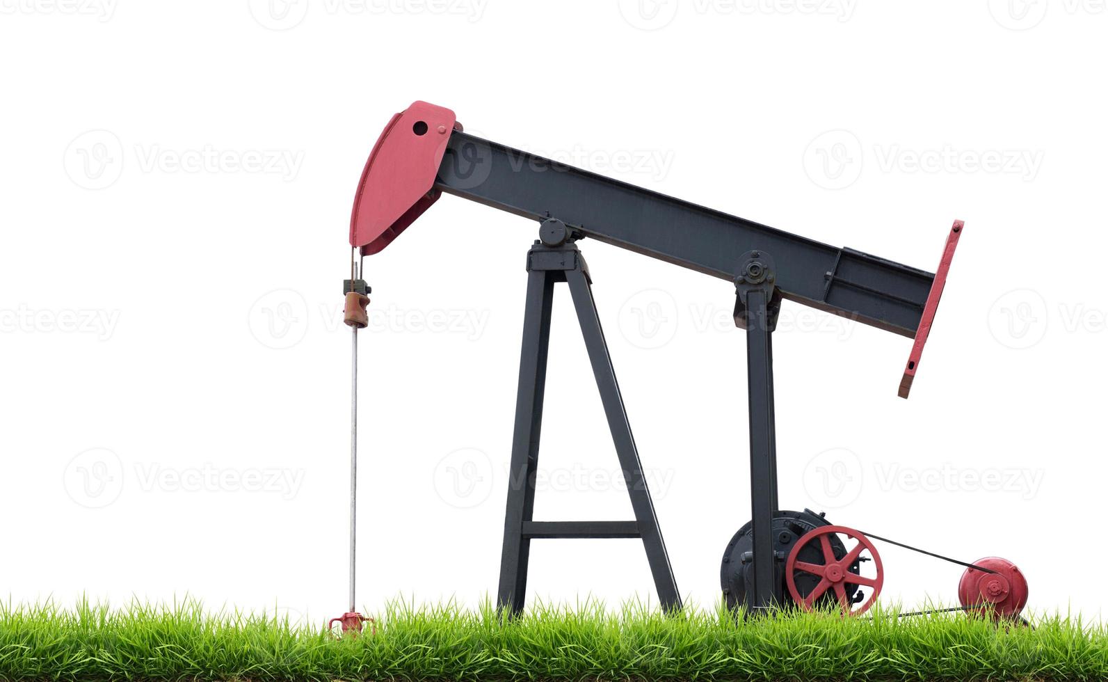 pumpjack with green grass isolated photo