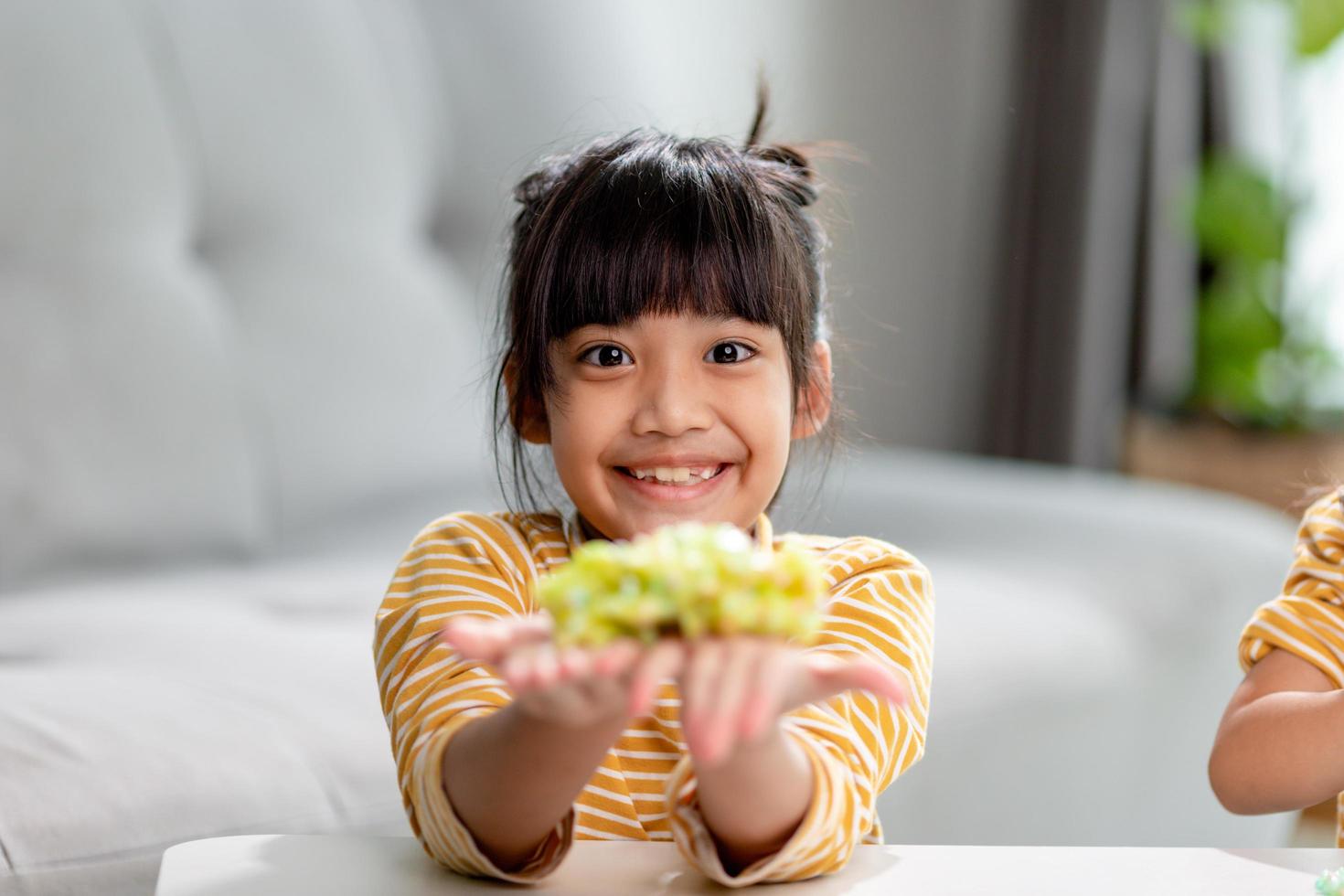 Kid play with handgum. Slime in children hands. photo