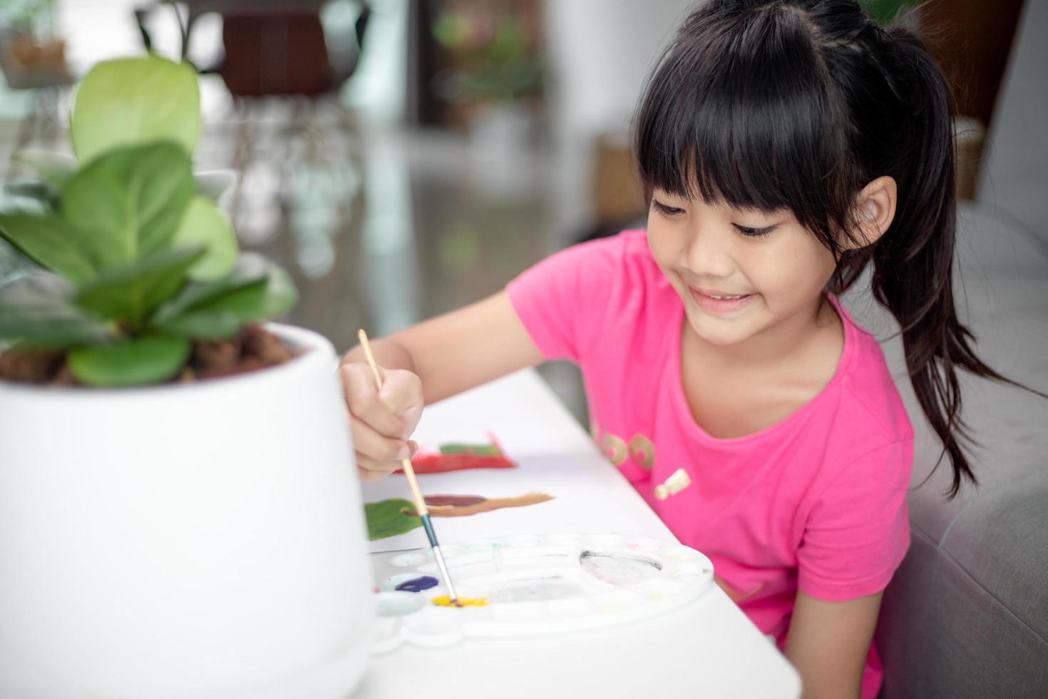 Girl Painting Picture On Table At Home photo