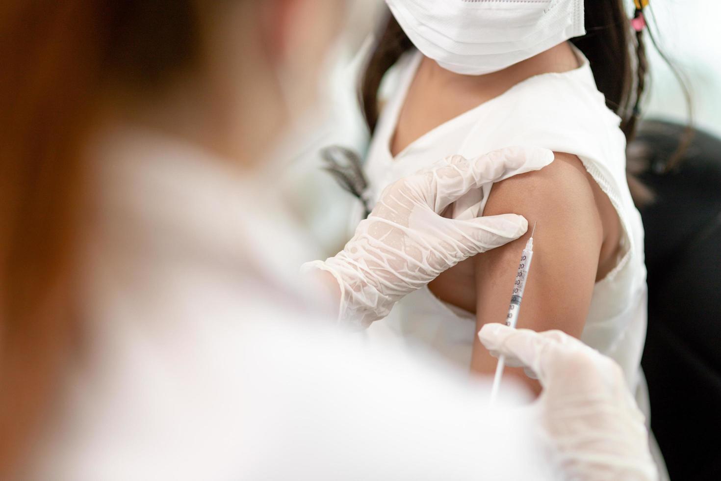 Successful covid-19 vaccination. cute little girl while being immunized against coronavirus photo