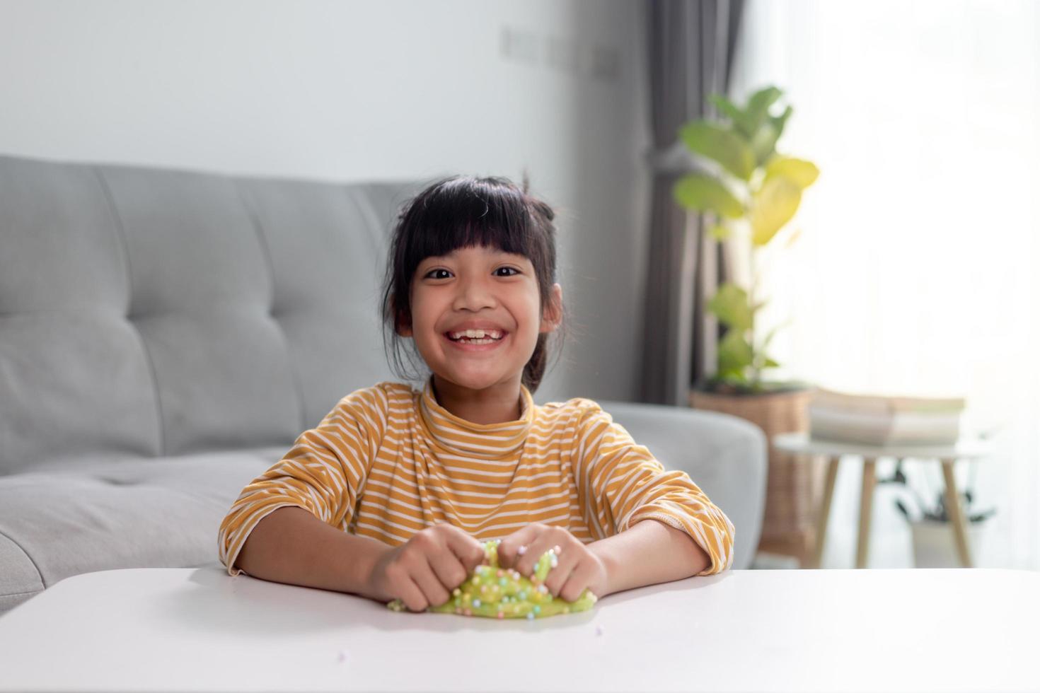 Kid play with handgum. Slime in children hands. photo