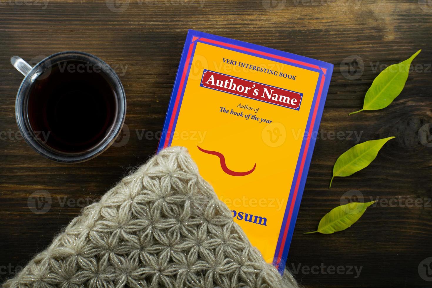Coffee and book with bright leaves on wood background. photo