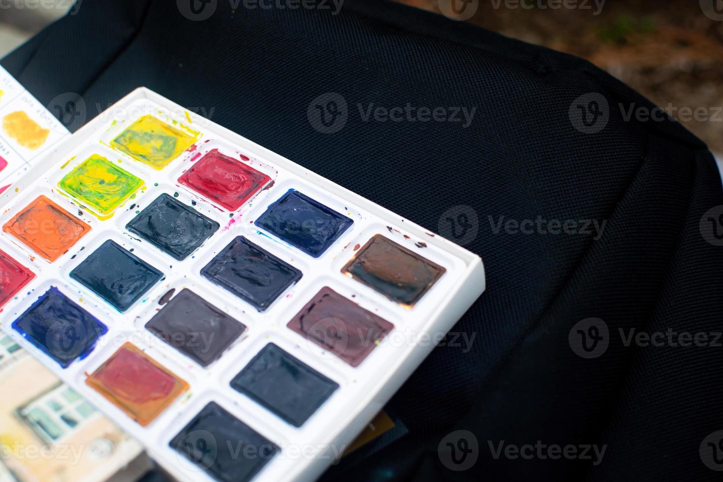 Set of watercolor paints. Watercolor for sketching in nature. photo