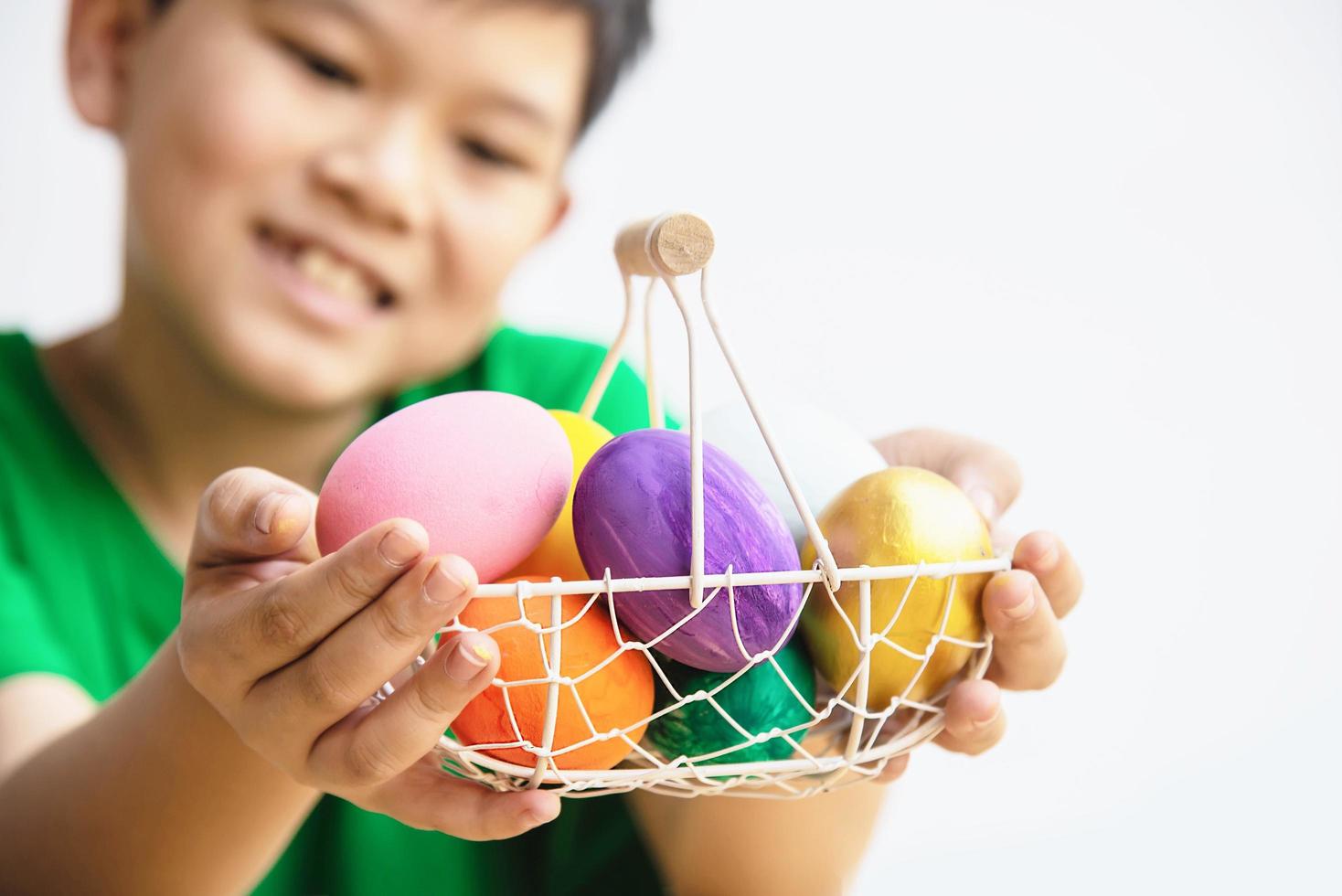 Child showing colorful Easter eggs happily - Easter holiday celebration concept photo