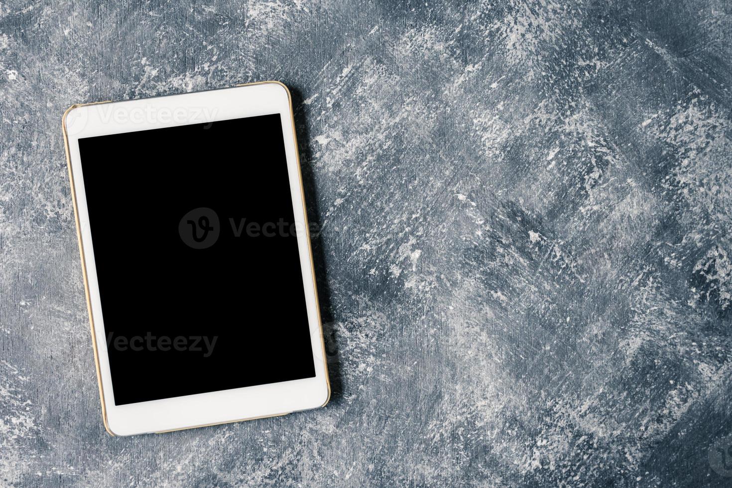 White tablet touch computer gadget with touch blank black screen on grunge background. photo