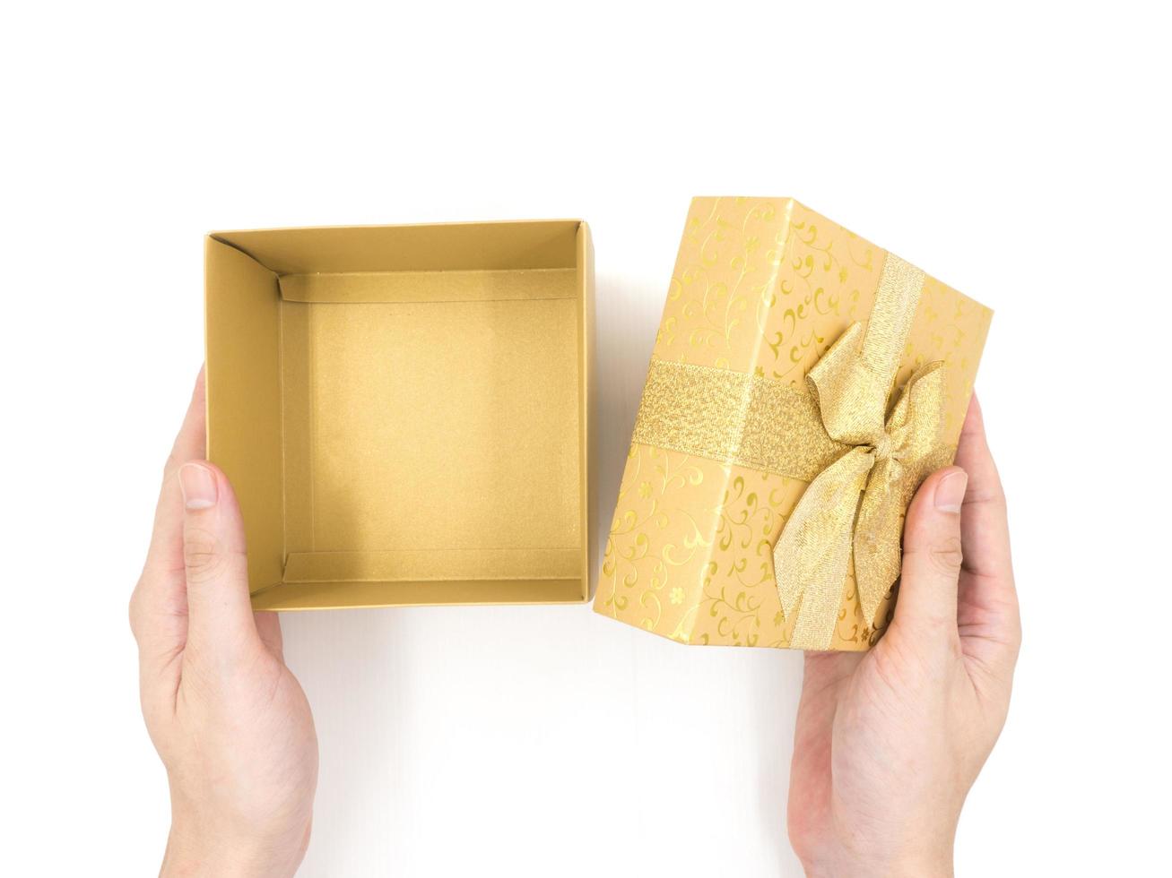 Hands opening Gift box on white background photo