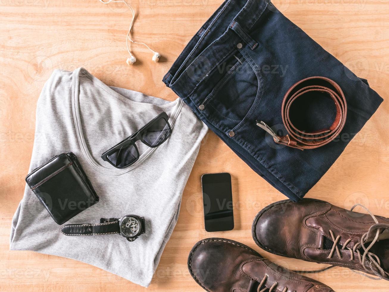 Top view of Men's casual outfits with accessories on wooden table background photo