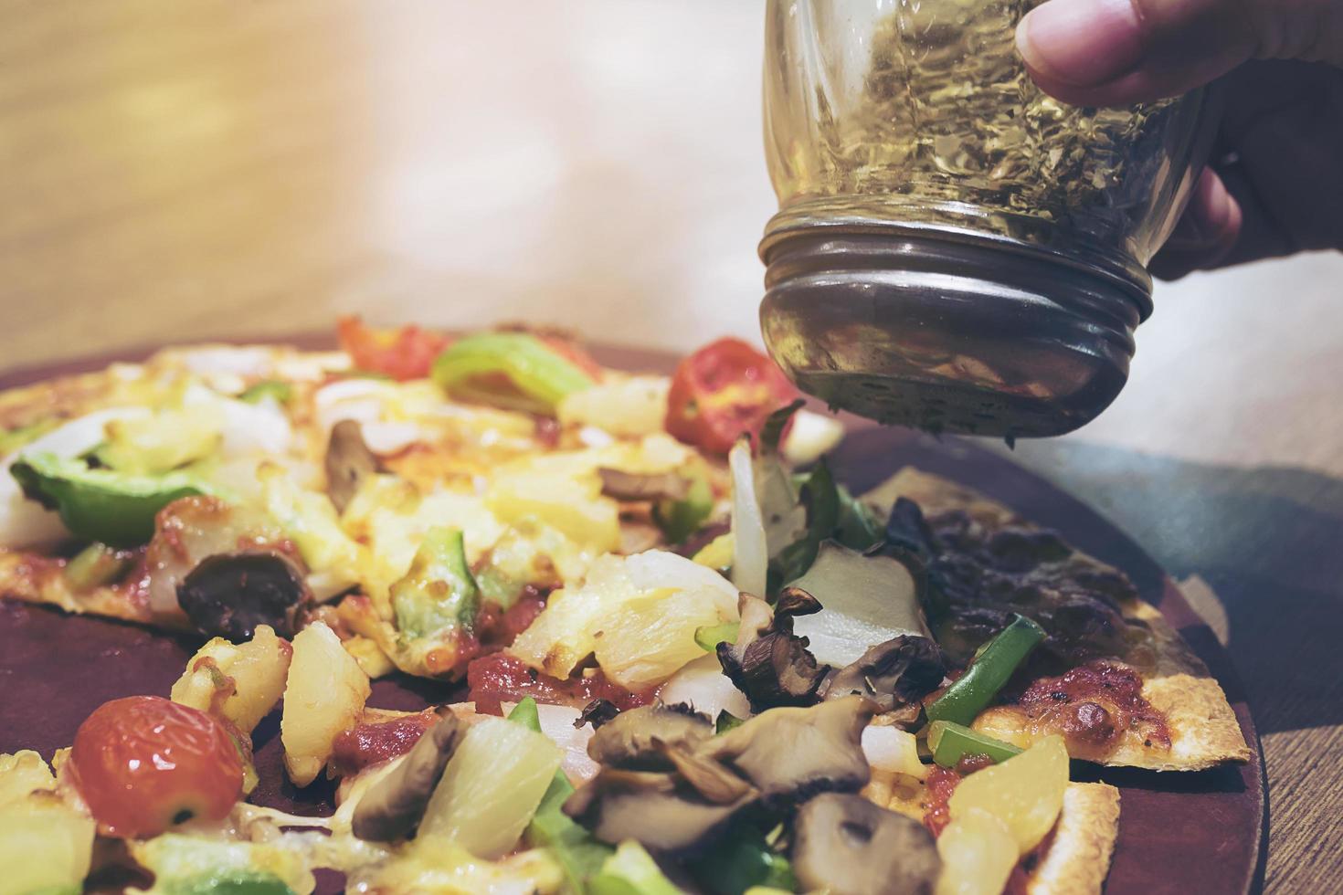 Vintage photo of pizza with colorful vegetable topping ready to be eaten