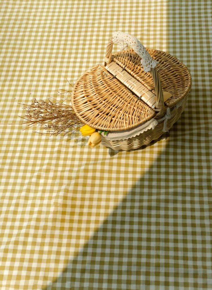 Basket picnic on yellow tablecloth. photo