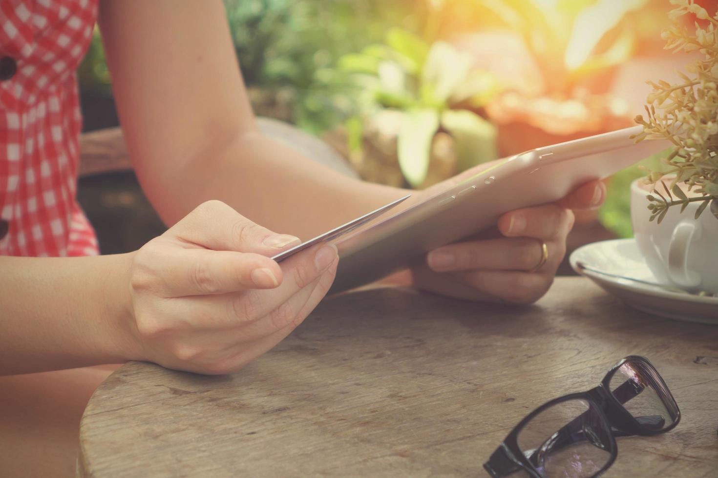 woman hands holding credit card and using laptop. Online shopping with vintage tone photo