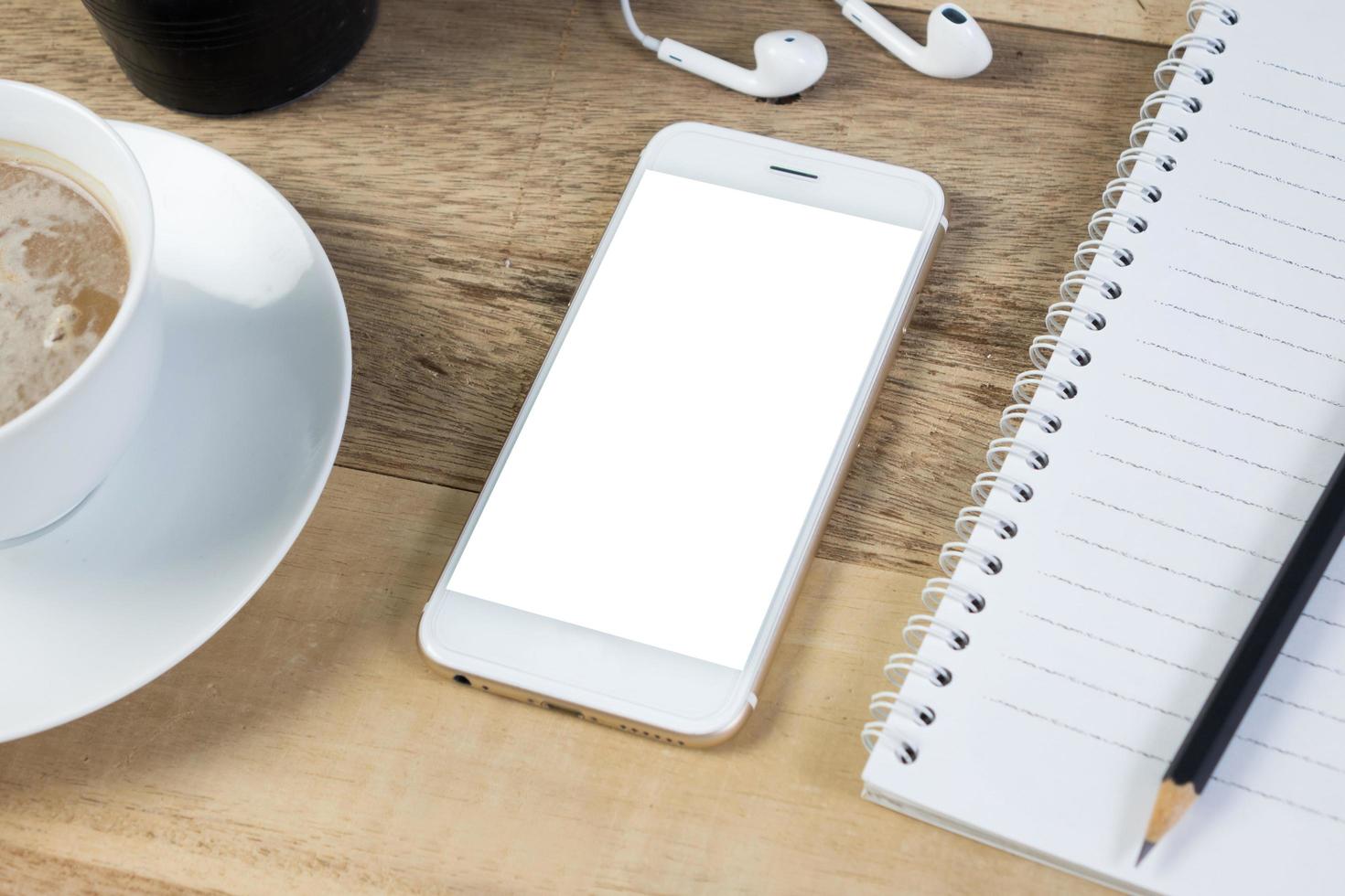 blank screen smart phone on wood desk work. photo