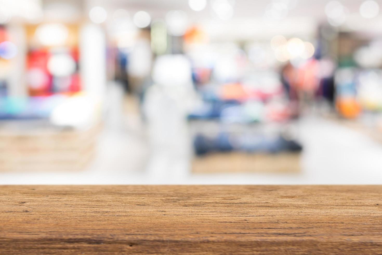 Wood table top on blur blurred store with bokeh background for display your products photo